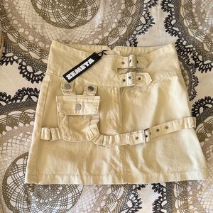Dolls Kill Cream Mini Skirt with Buckle Detail